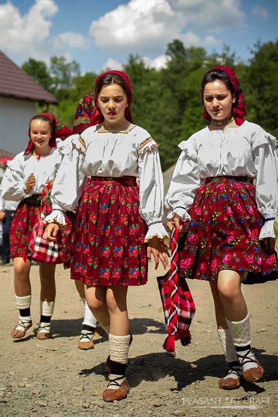 Dames posing in traditional Romanian folk costumes from Maramureş